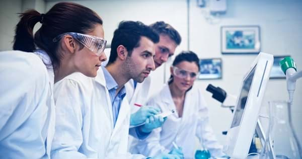 Researchers looking at results on computer